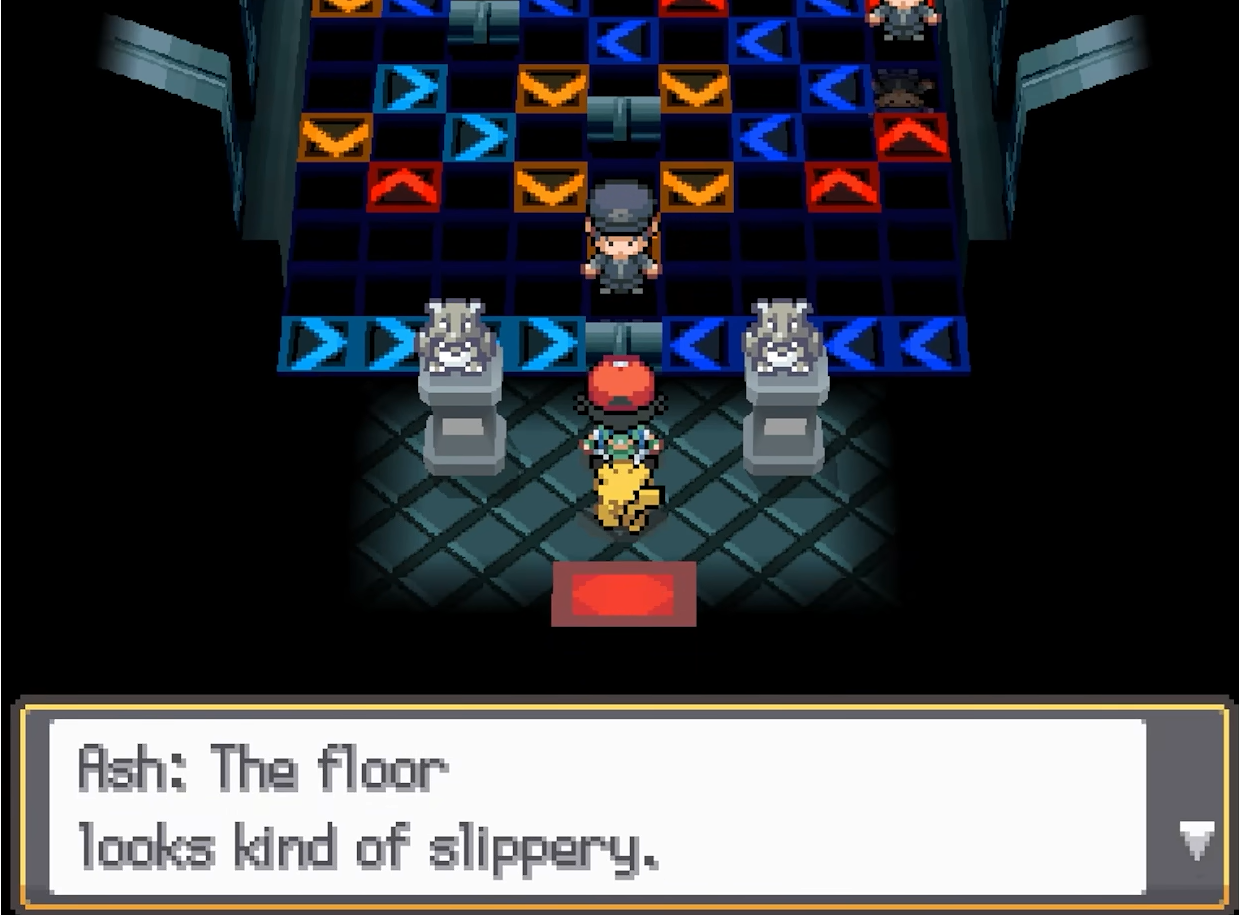 Ash speaks while standing on a floor covered with directional arrow tiles.